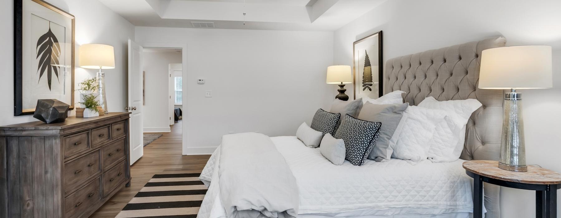 a bedroom with a bed and lamps