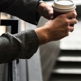 man holding cup of coffee