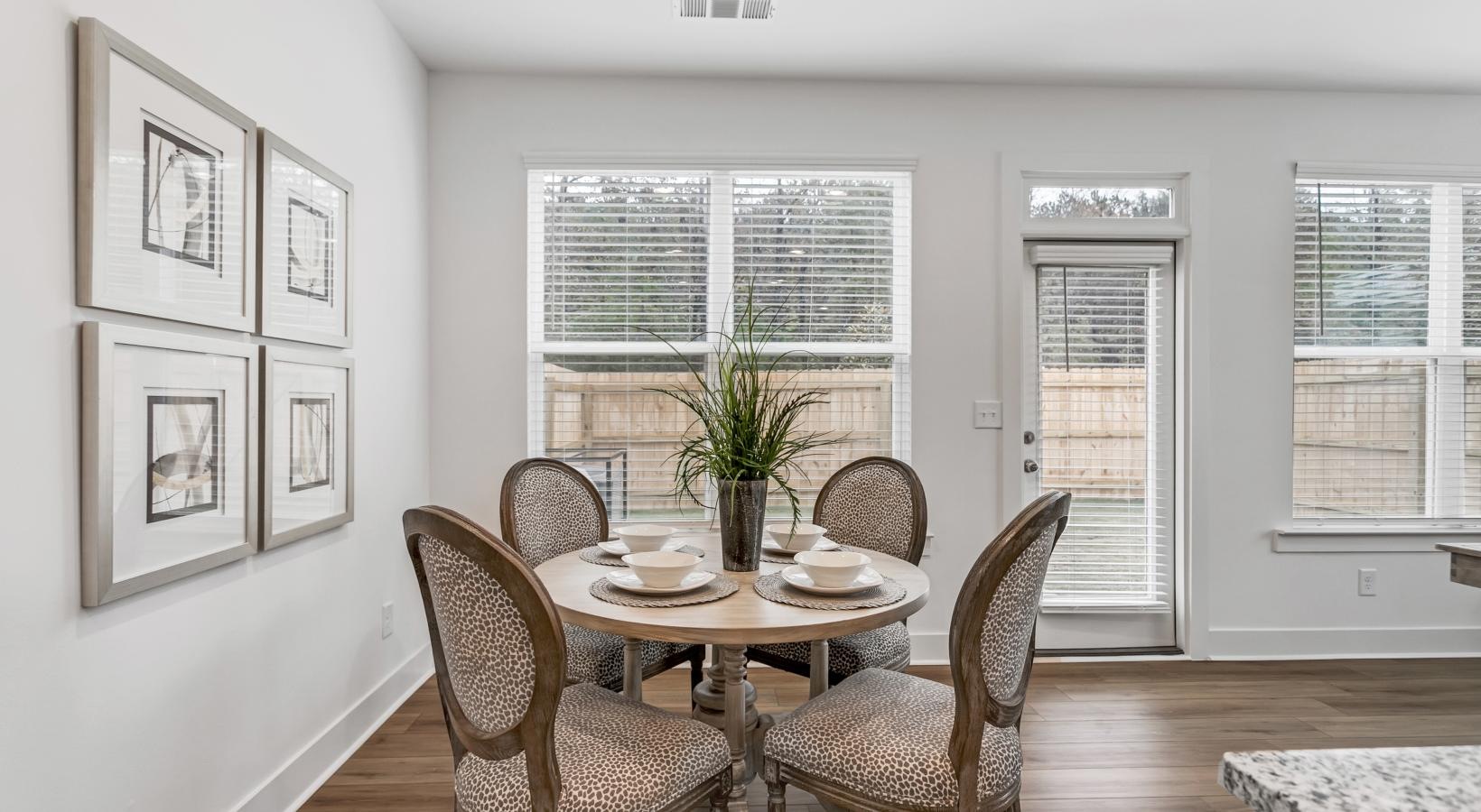 Gorgeous living areas to entertain and enjoy a dining room table with chairs and a plant on it