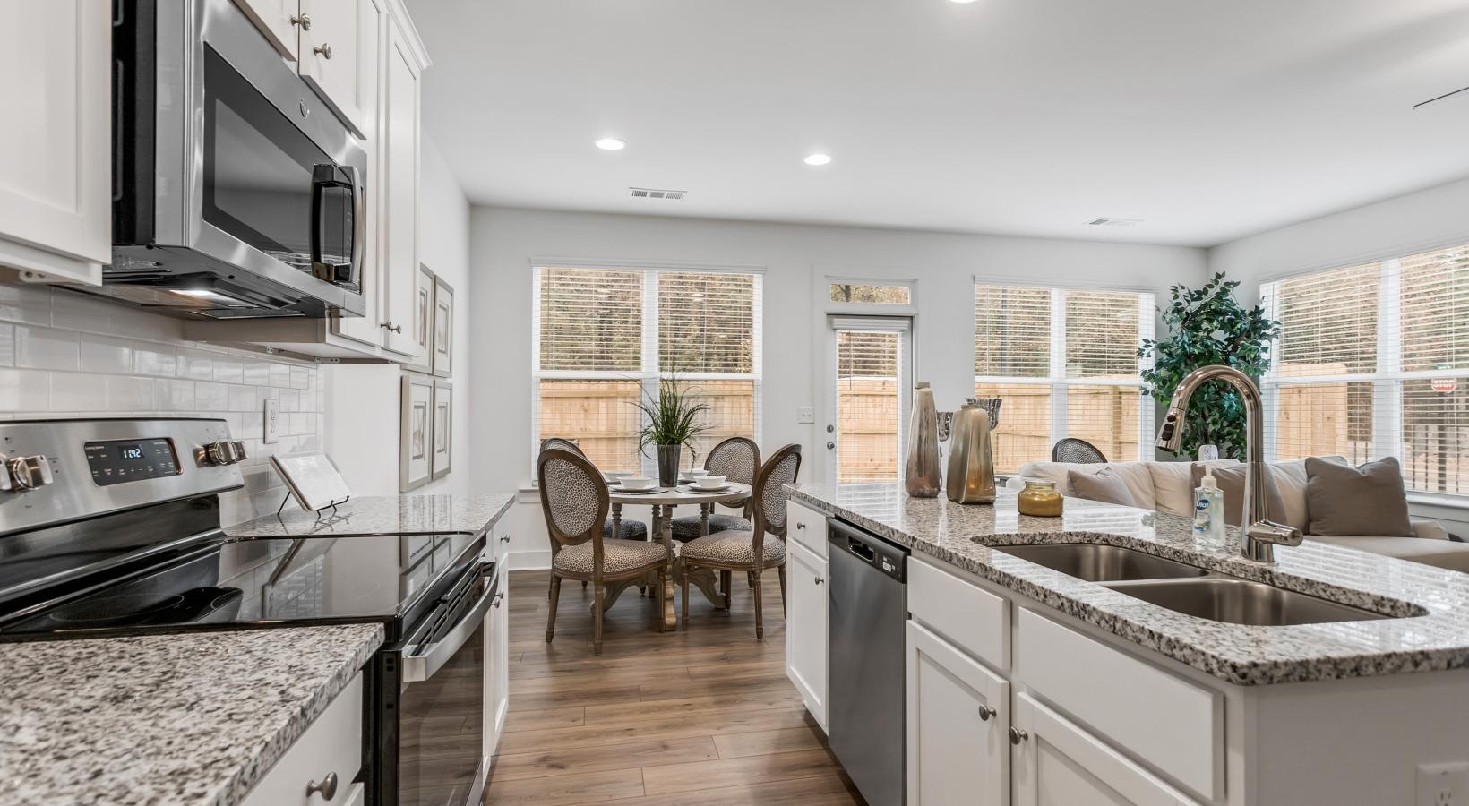 Beautiful kitchens with designer finishes a kitchen with a table and chairs