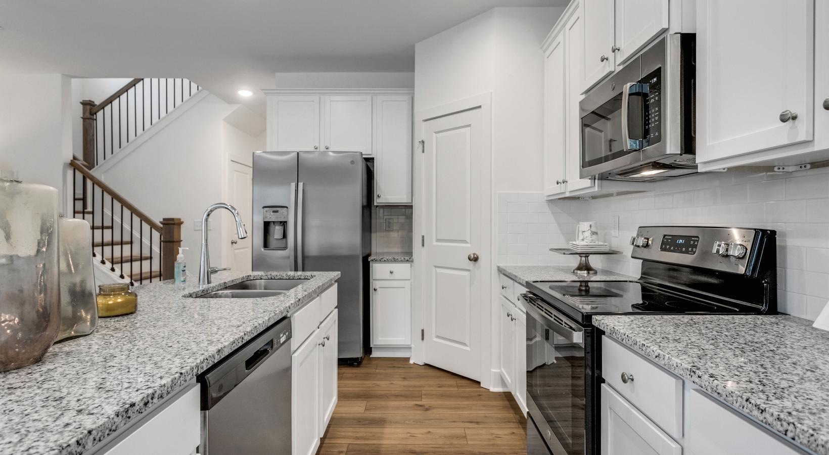 Spacious kitchens with thoughtful details a kitchen with white cabinets