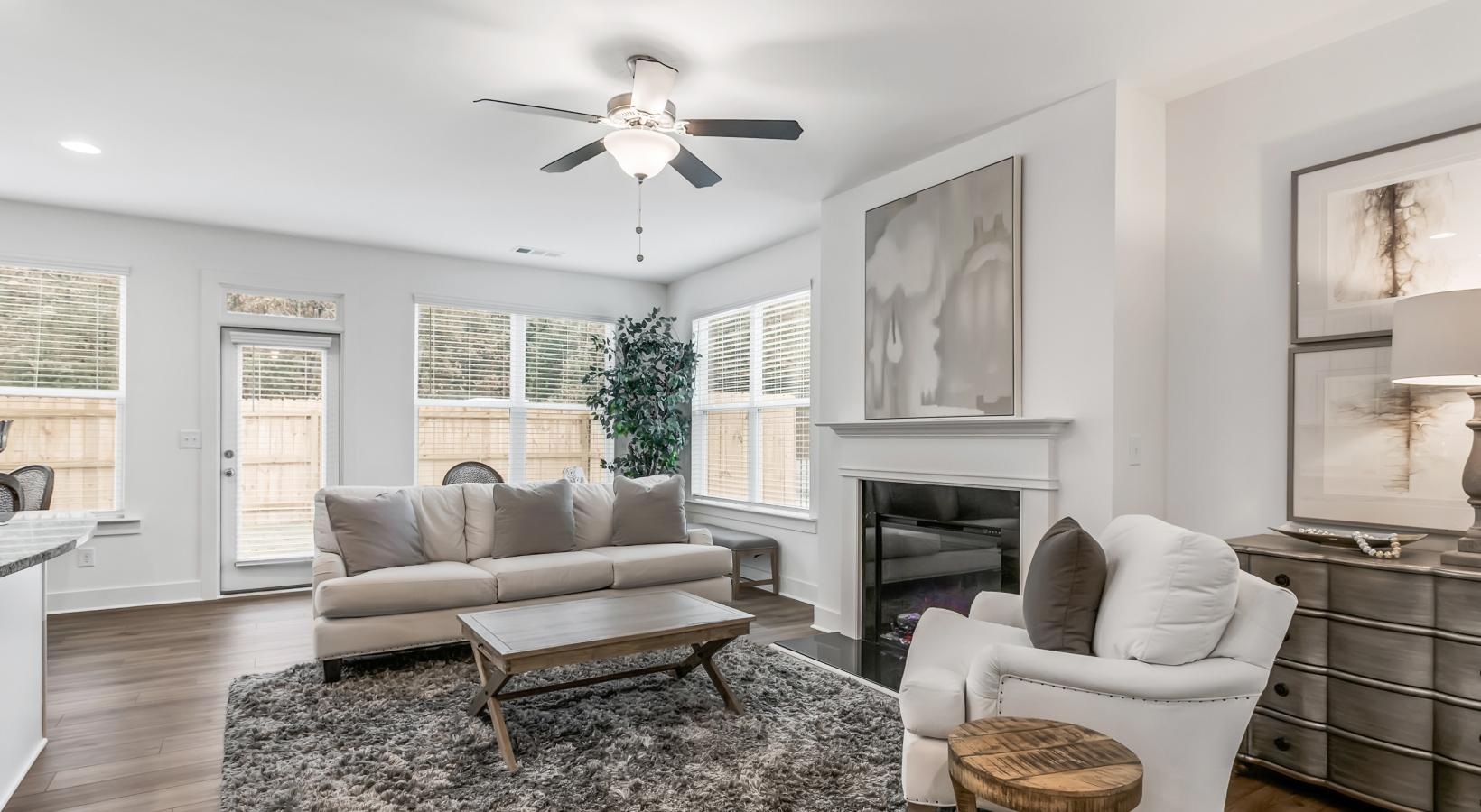 Spacious and well-lit living spaces a living room with a fireplace and a couch