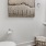 a bathroom with a toilet mirror and sink