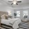 a bedroom with a bed and a fan