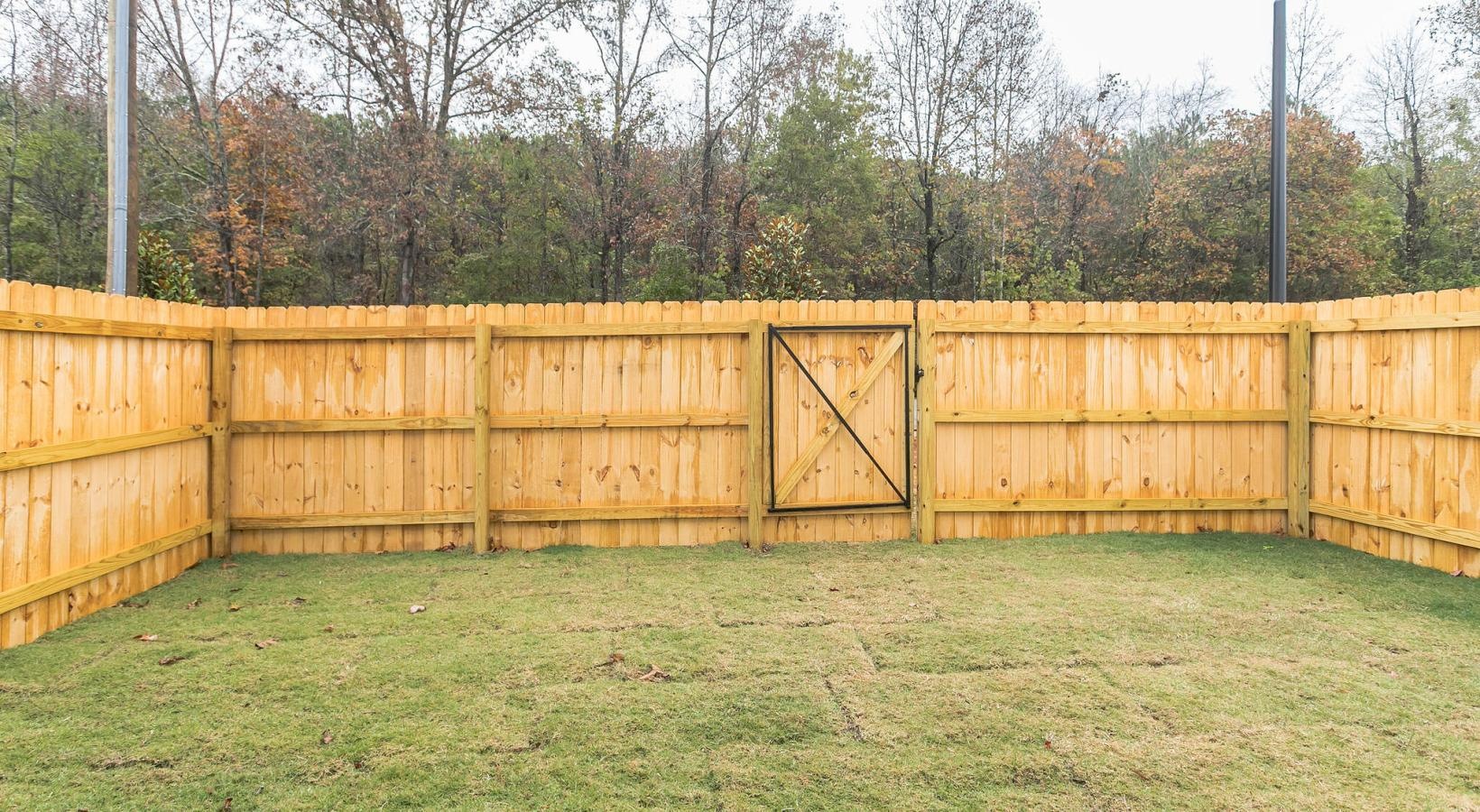 Find your perfect fit at Centennial Ridge a backyard with grass and wood fence